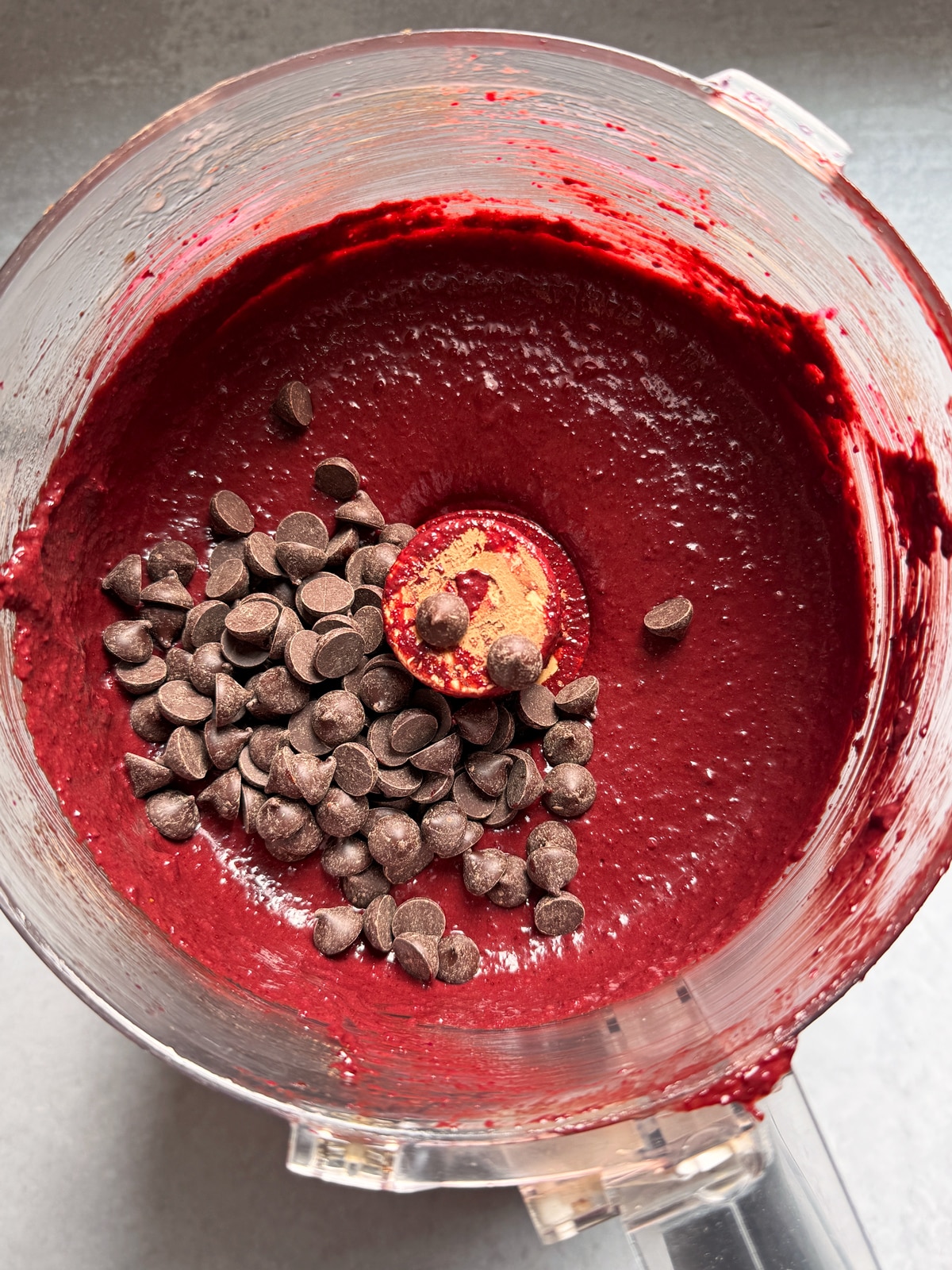 Adding the chocolate chips to the blended muffin ingredients.