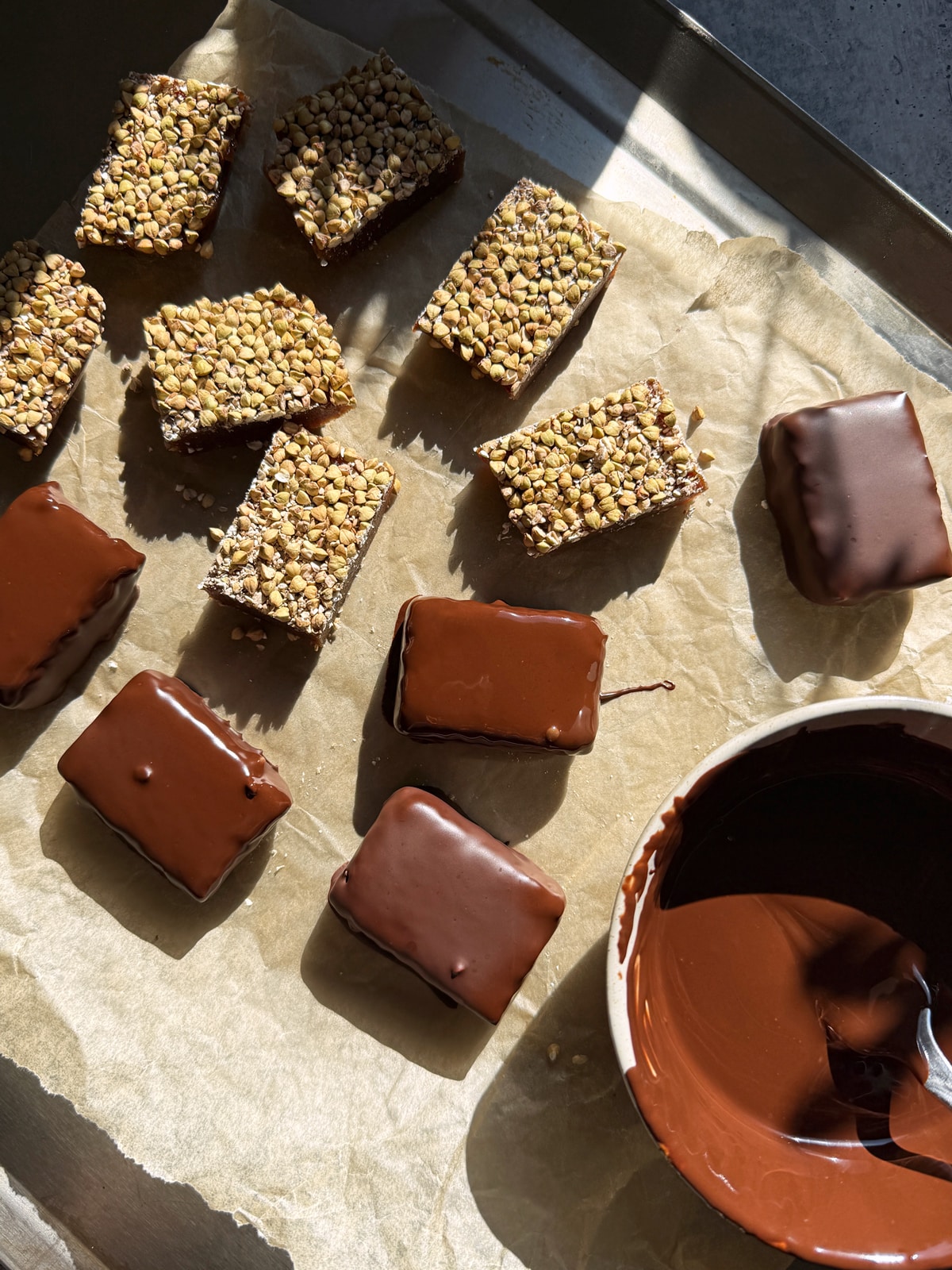 Dipping the bars in melted chocolate.