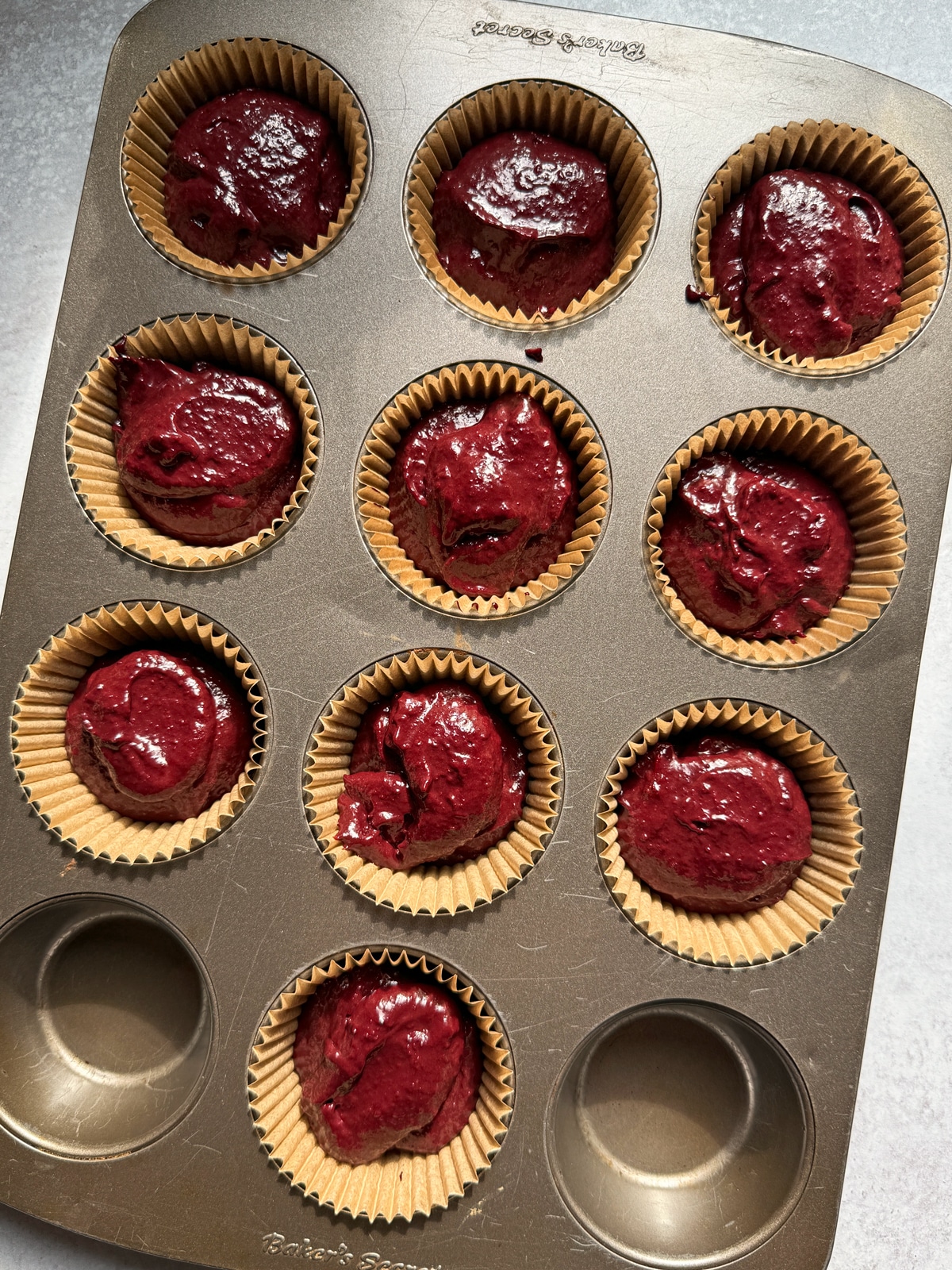 Batter in lined muffin pan.