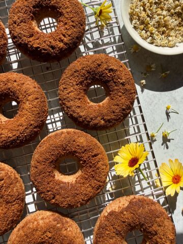 Top down view of donuts on wire cooling rack.