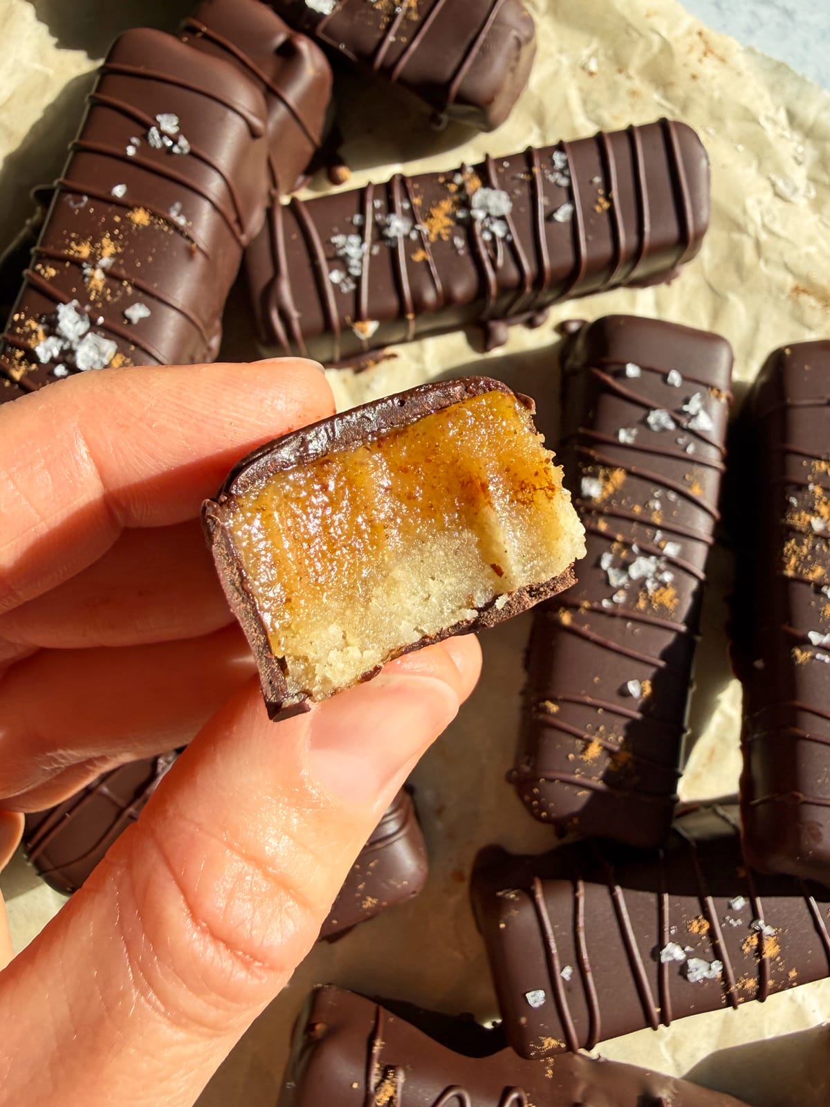 Holding a pumpkin twix with a bite out of it to show the texture.