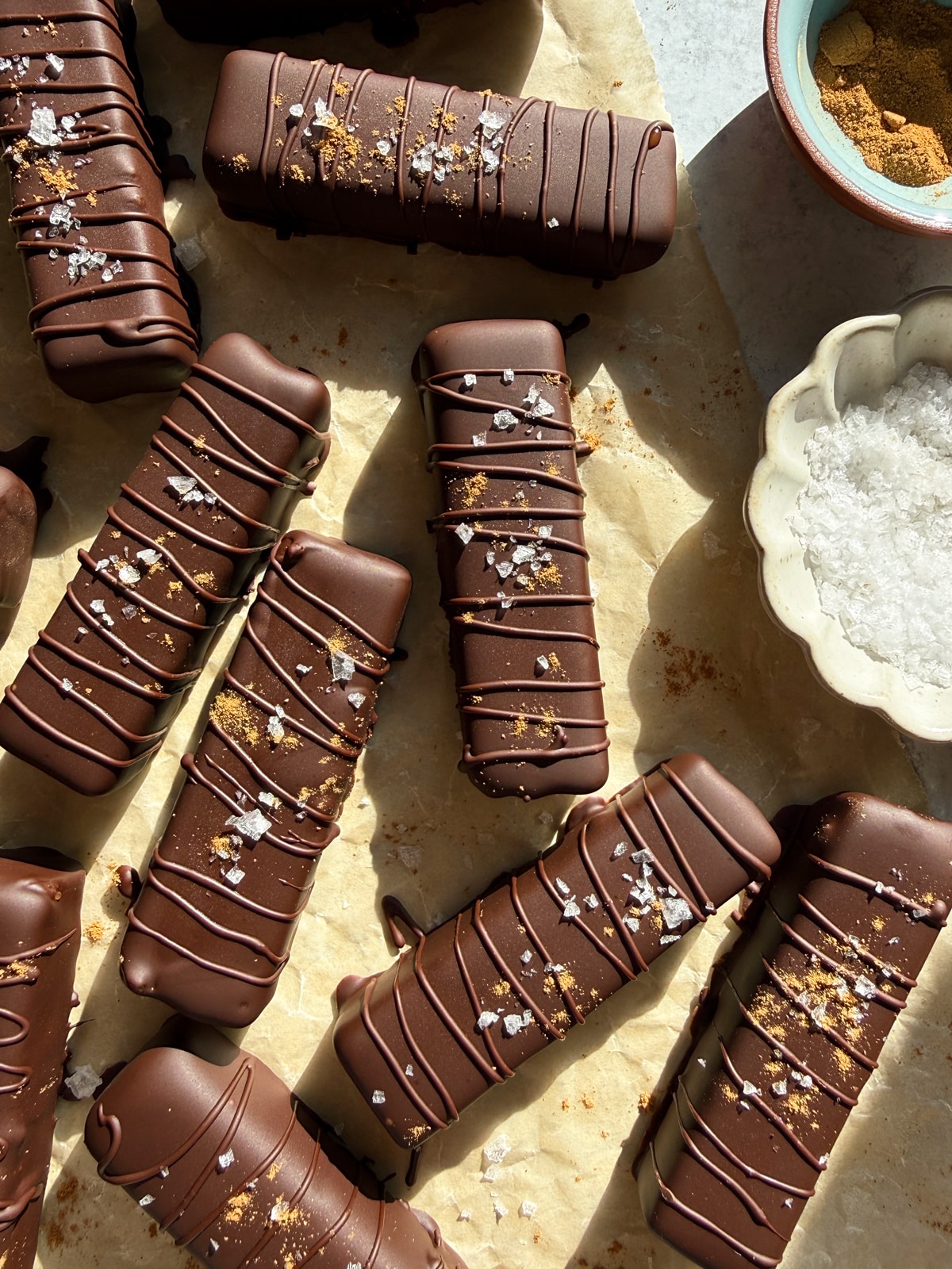 Top down view of pumpkin twix bars decorated with flaked salt and cinnamon.