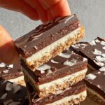 Grabbing a bar from a stack of 4 coconut butter bars.