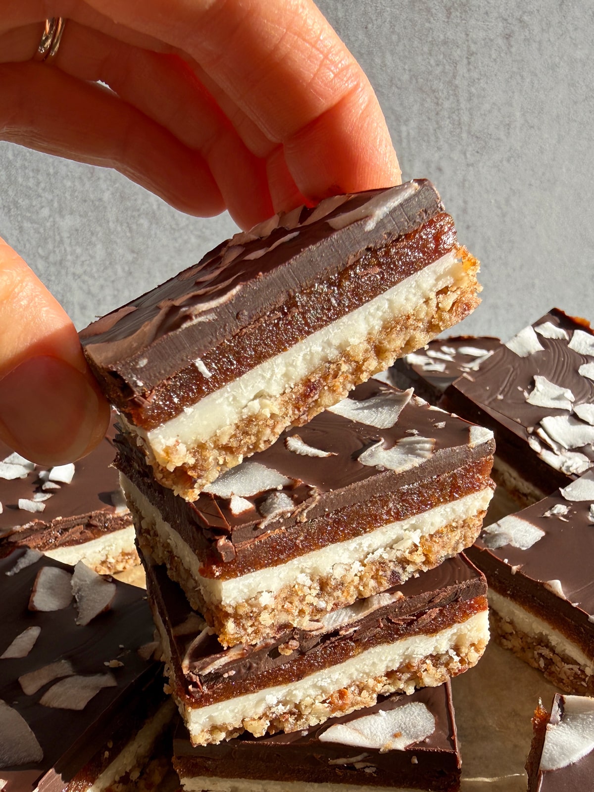 Grabbing a bar from a stack of 4 coconut butter bars.