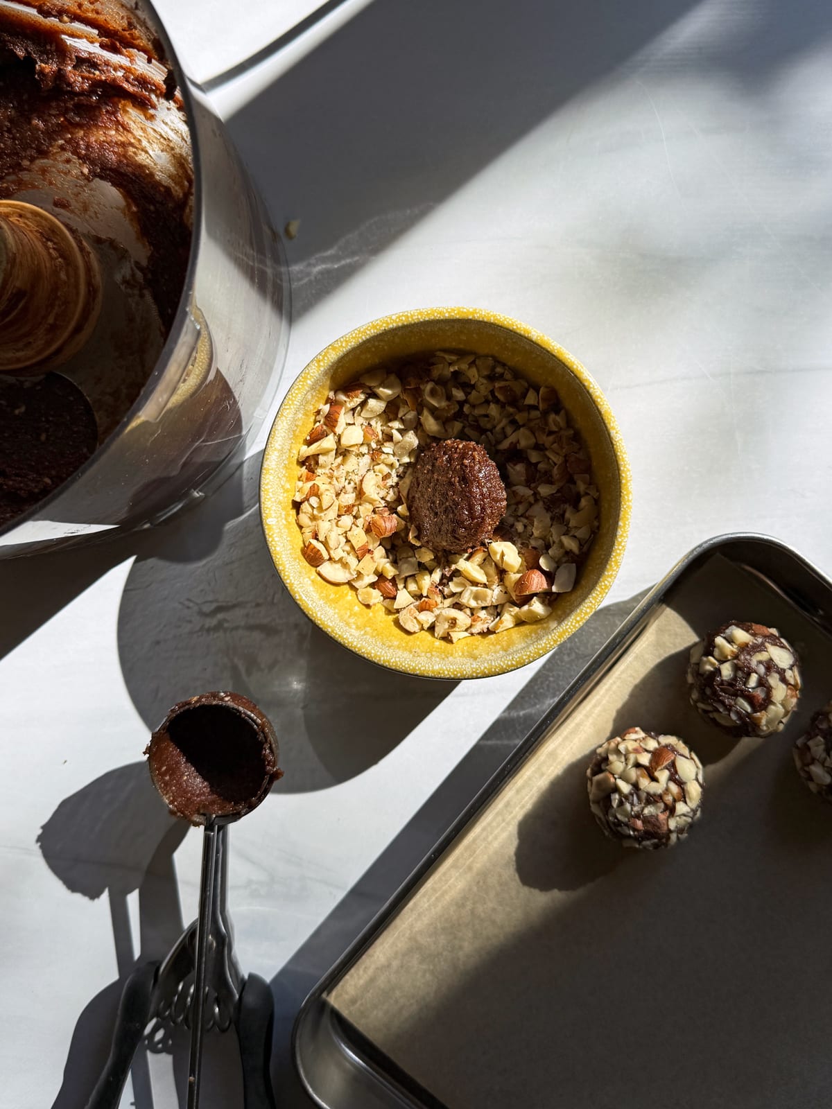 Rolling the truffle filling in chopped hazelnuts.