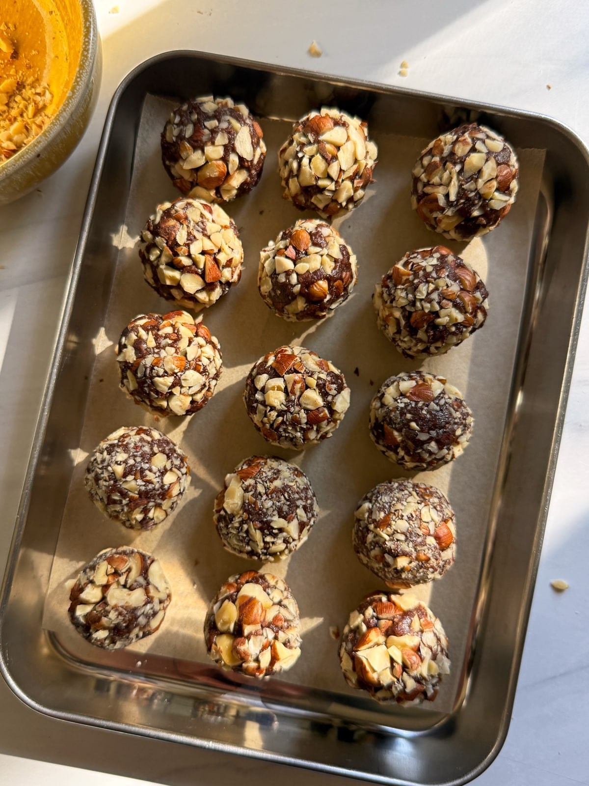 Rolled fillings on a lined baking sheet, ready to freeze.