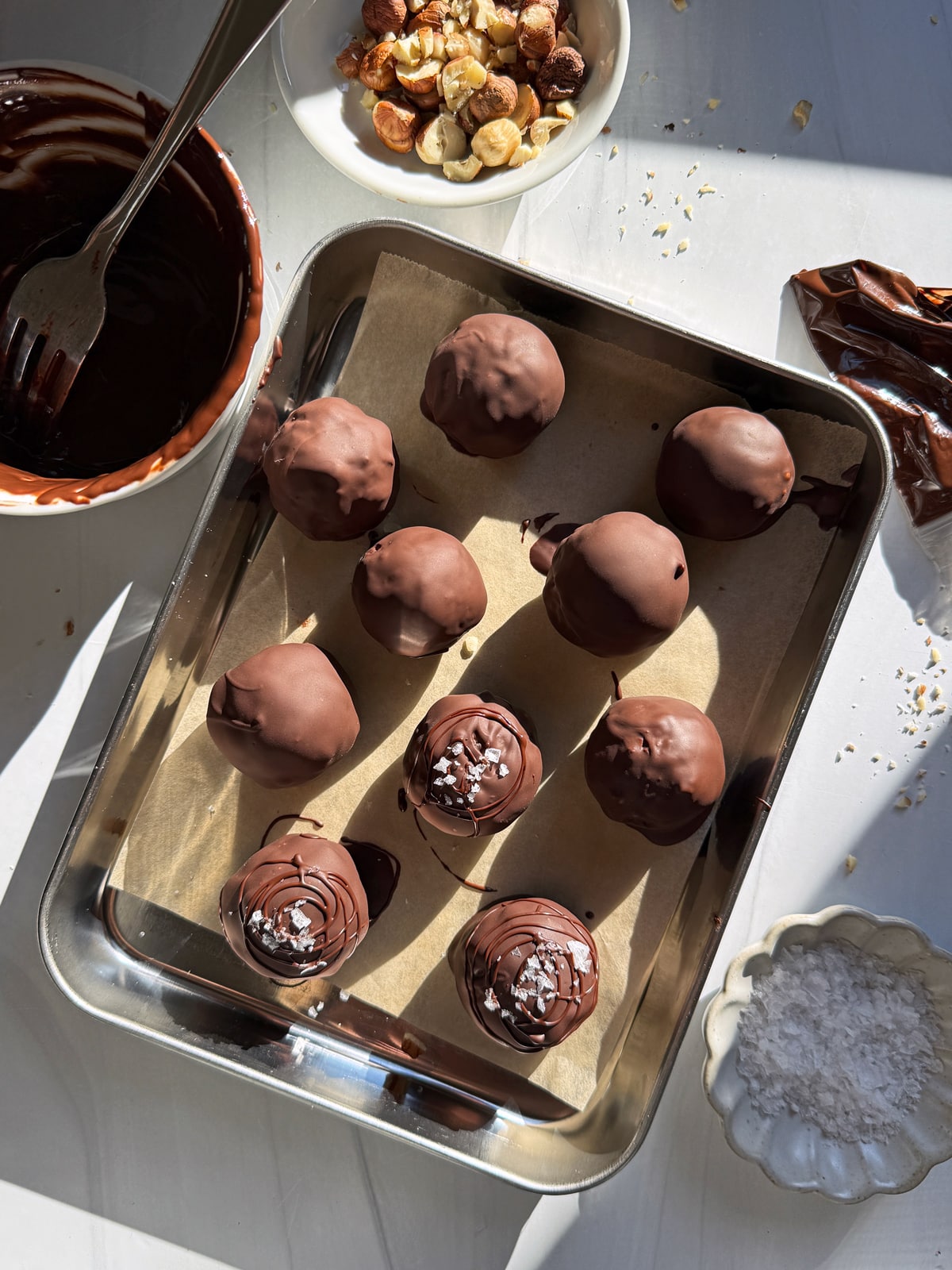 Dipping the truffles in dark chocolate.