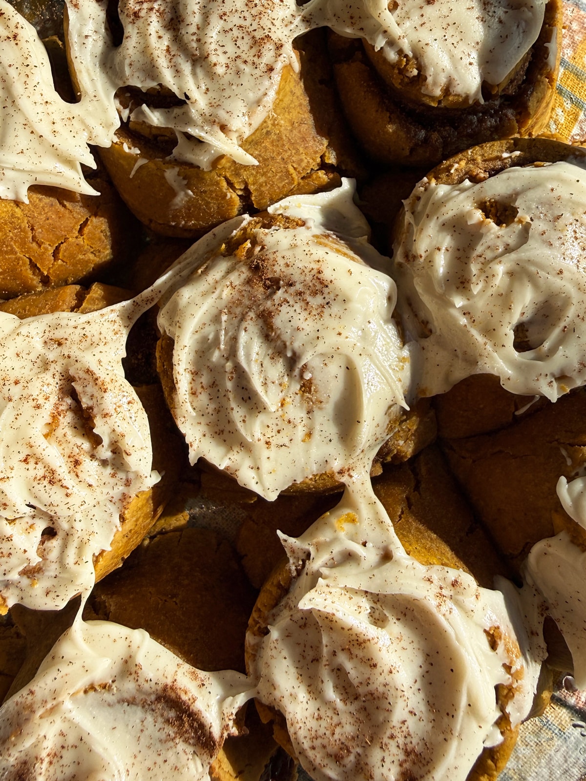 Top down view of frosted cinnamon rolls.