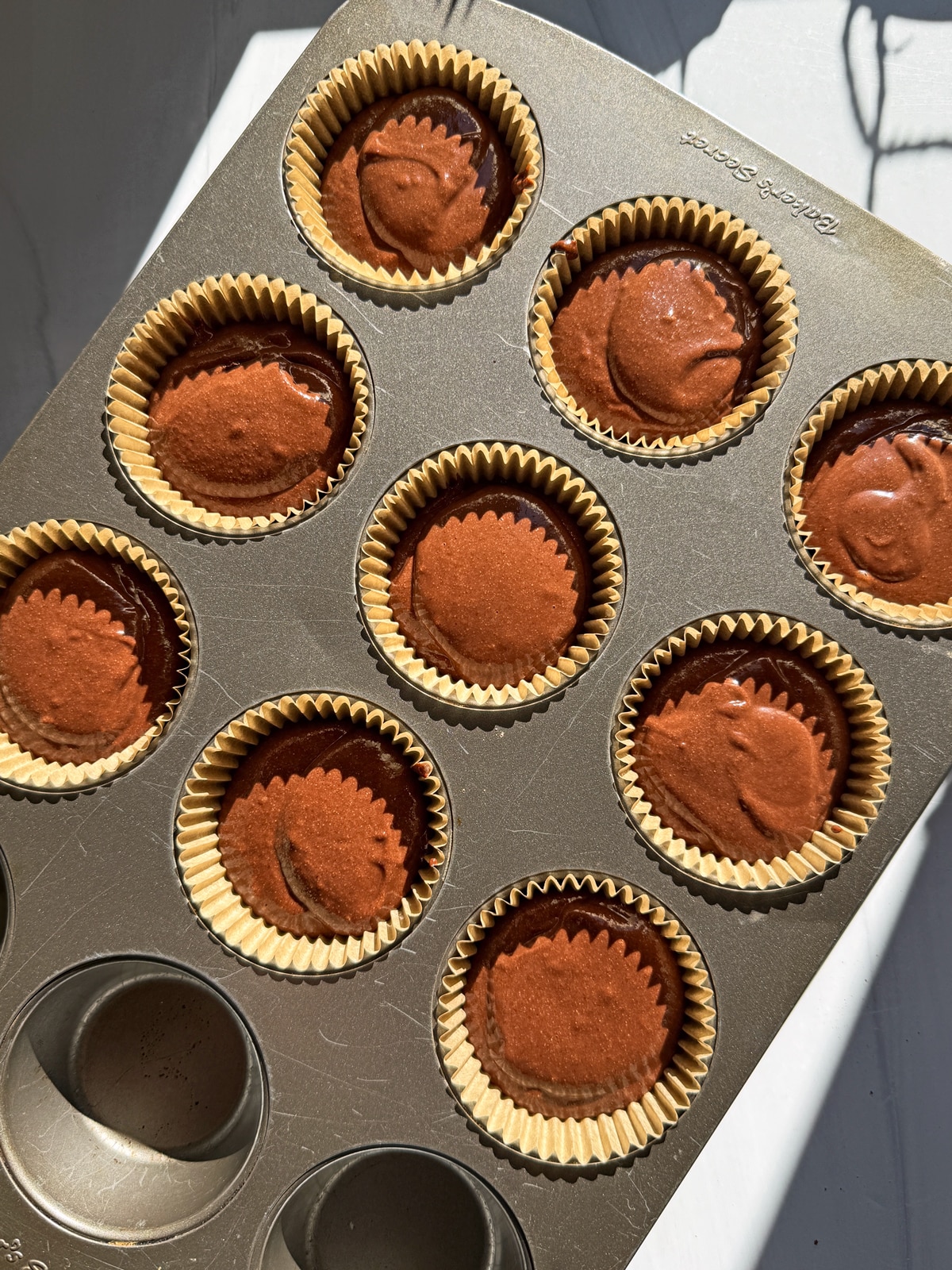 Muffin batter in muffin tin, ready for the oven.