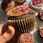 Holding a paleo vegan chocolate cupcake.