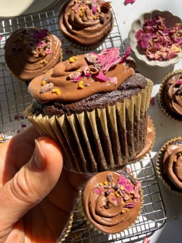 Holding a paleo vegan chocolate cupcake.