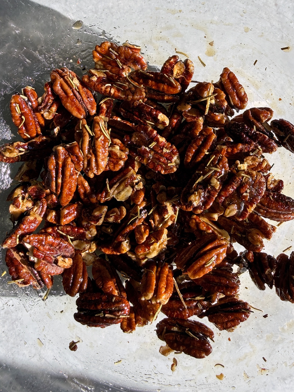 Coating the pecans in a mixing bowl.