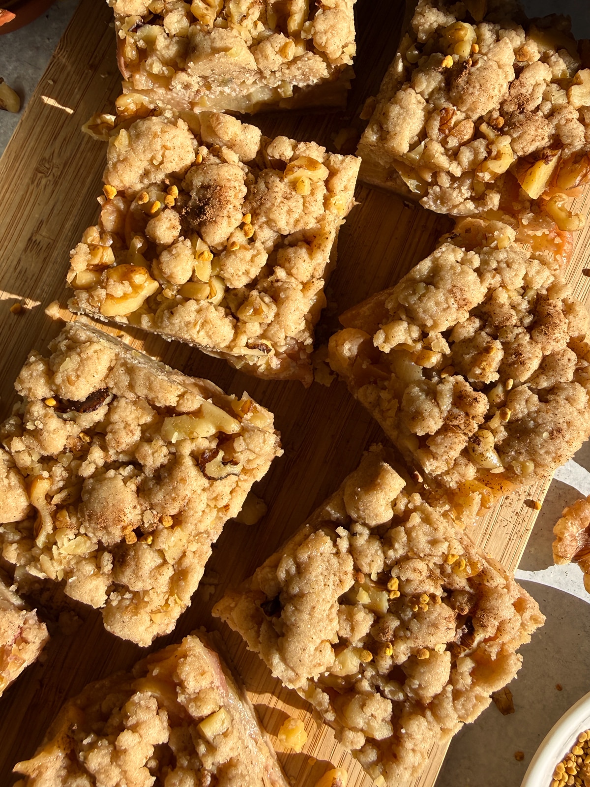 Apple walnut crumb bars on cutting board.
